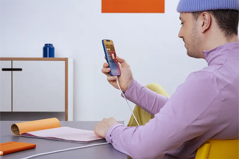 Person plays on their mobile phone.