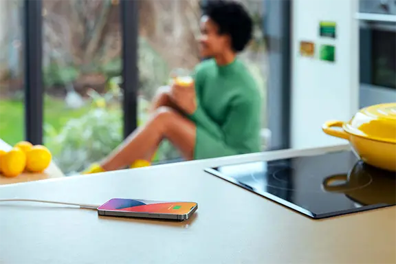 Mobile phone is being charged in the kitchen.