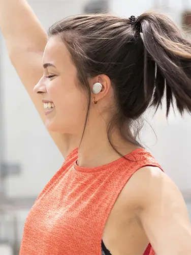 Person wears the true wireless headphones in the ear.