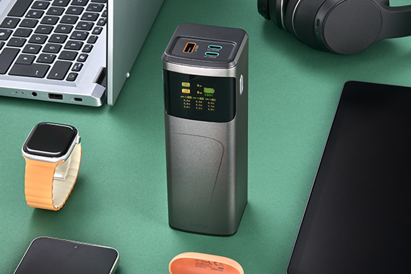 Mobile battery surrounded by many devices. It has three connections for three devices.