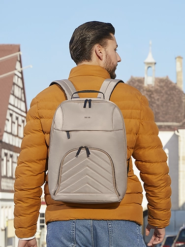 A young man is out and about in the city with the Hama "Premium Lightweight" laptop rucksack on his back