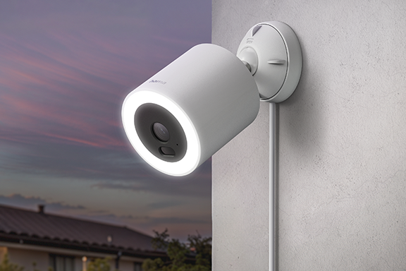 The smart surveillance camera is mounted on the wall of the house and aligned.